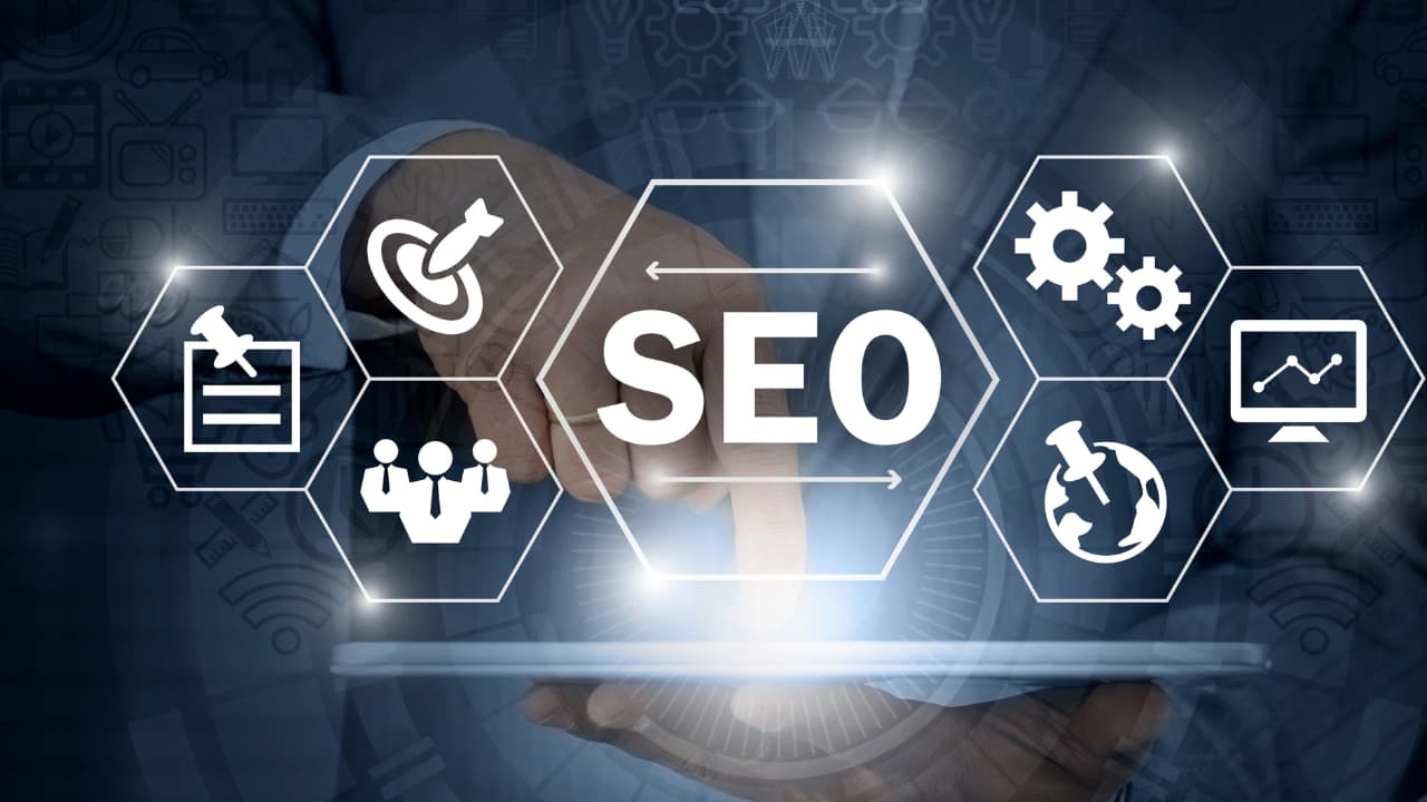 A person uses a tablet with "SEO" and related icons like a target, gears, and graph overlayed. The image has a digital, business-oriented tone.