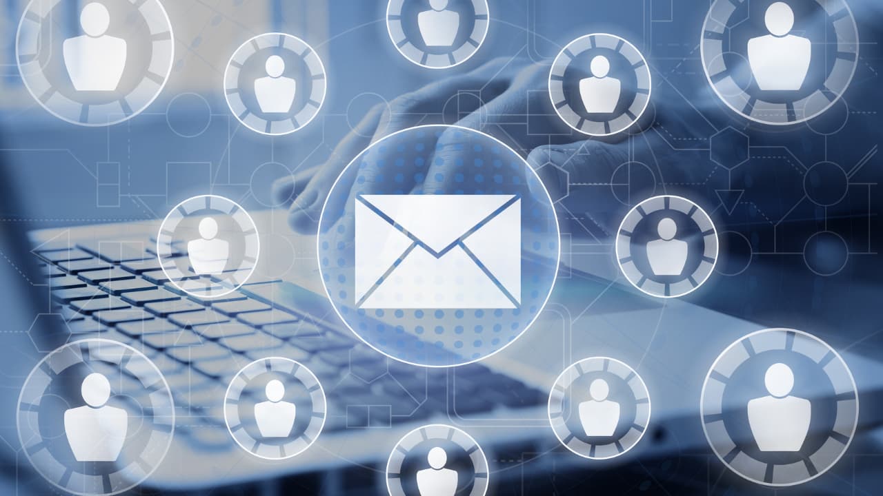 A person typing on a laptop, overlaid with digital icons of people and a large email symbol. The image conveys communication and networking themes.