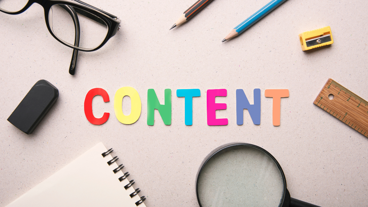 Colorful letters spelling "CONTENT" are surrounded by glasses, pencils, a ruler, an eraser, a magnifying glass, and a notebook on a beige surface.