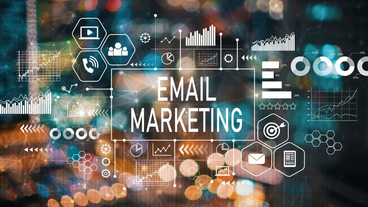 Alt text: "The words 'Email Marketing' are centered amidst an overlay of digital icons and charts, symbolizing analytics and communication, against a blurred cityscape."