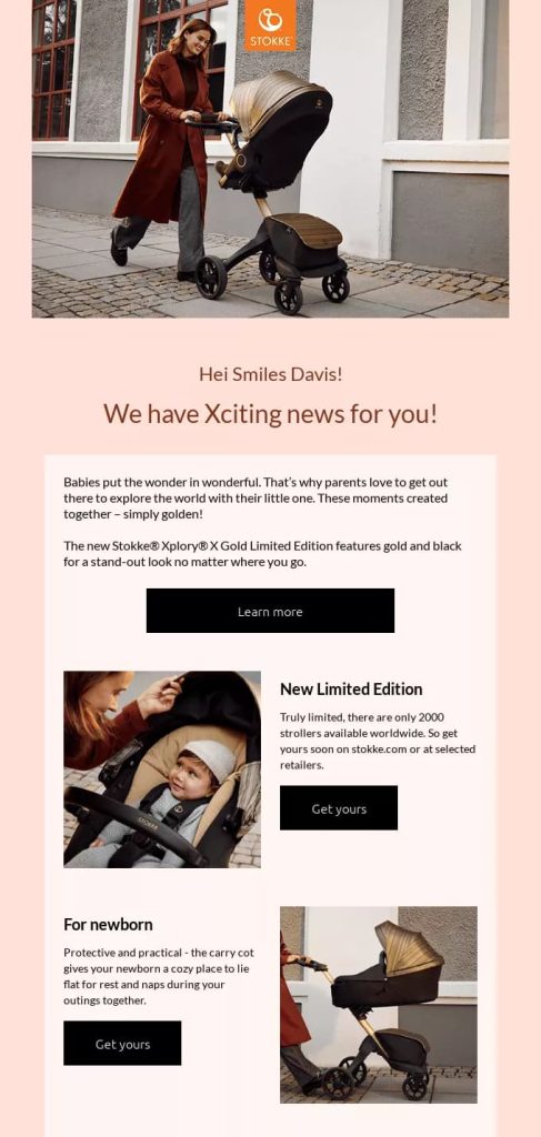  woman in a long coat pushes a stylish black and gold stroller on a cobblestone path. The tone is elegant and sophisticated, highlighting a new limited edition stroller collection. Keywords: stroller, limited edition, fashionable, parent, outdoor.